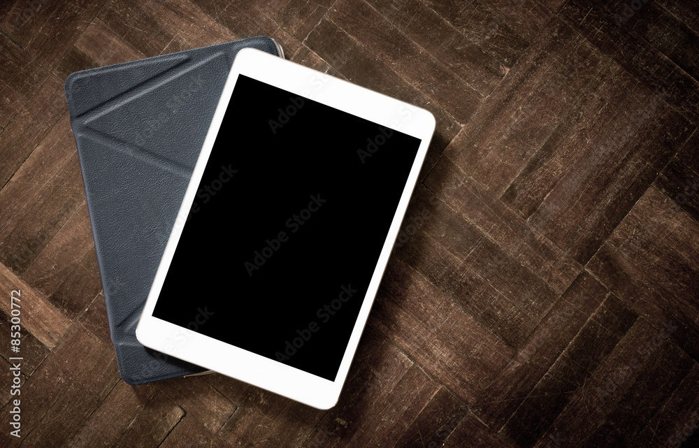 White digital tablet on the wooden floor White digital tablet on the wooden floor