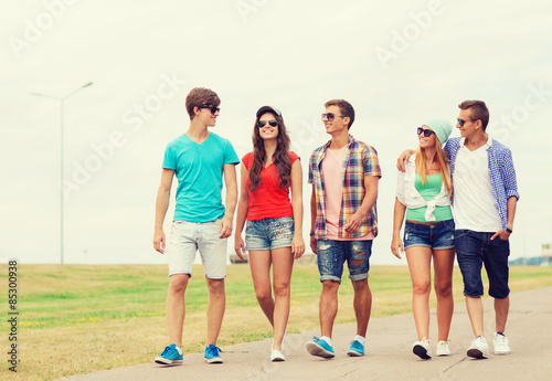 group of smiling teenagers walking outdoors