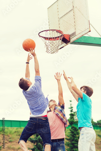 group of teenagers playing basketball