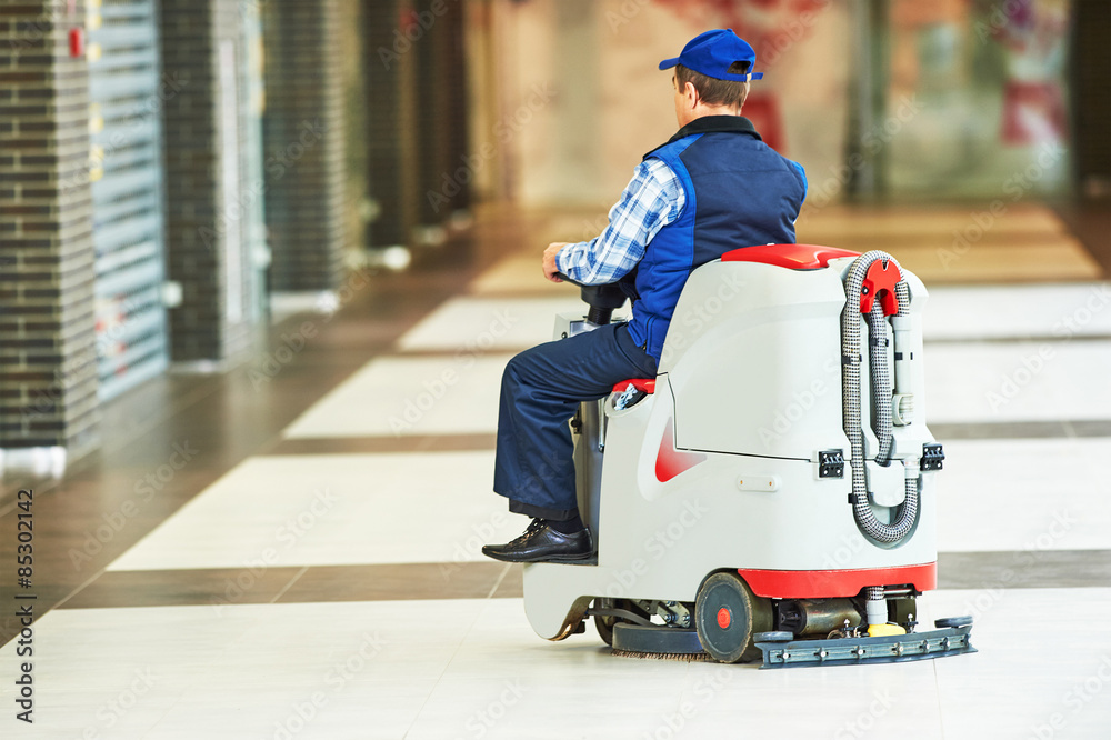 worker cleaning store floor with machine worker cleaning store floor with machine