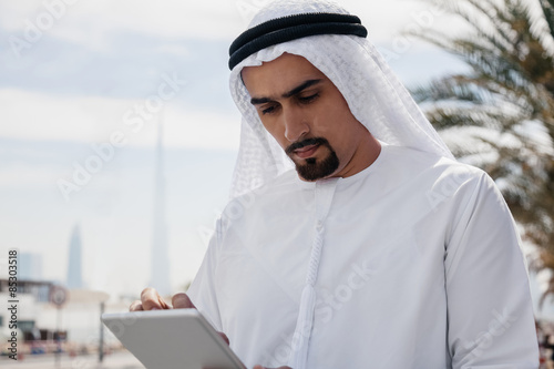 Arabian Businessman Using Digital Tablet photo