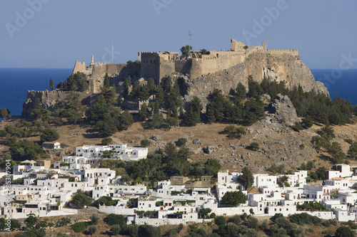 View of Lindos with it's ancient Acropolis and beach. Island of Rhodes, Greece