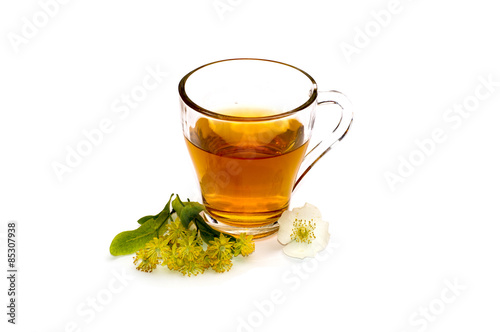 the glass of bright red tea decorated with a small flower