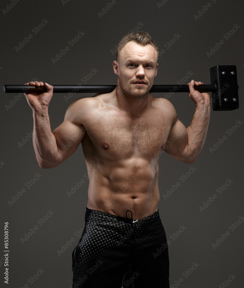 Muscular shirtless guy holding big hummer