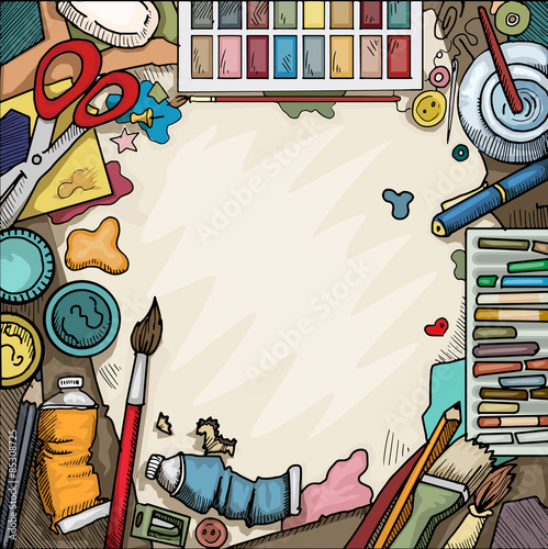 Background, Ariel view of arts and crafts table with various objects surrounding a blank piece of paper