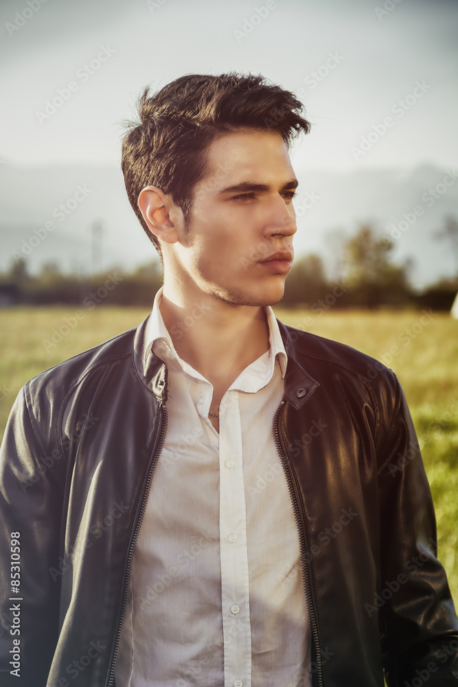 Handsome young man at countryside, in front of field or Handsome young man at countryside, in front of field or
