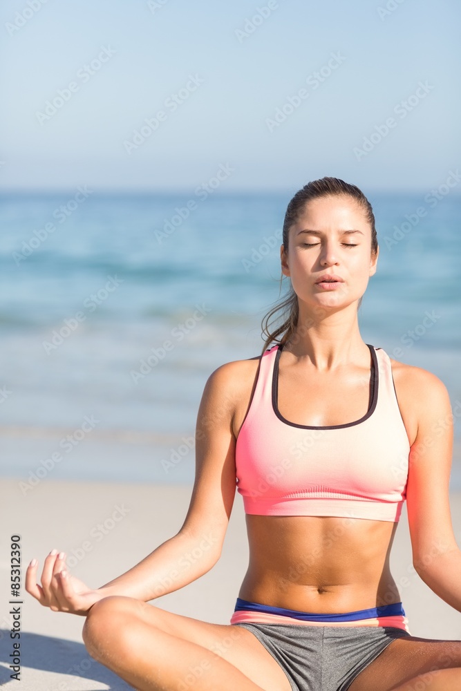 Fit woman doing yoga beside the sea Fit woman doing yoga beside the sea