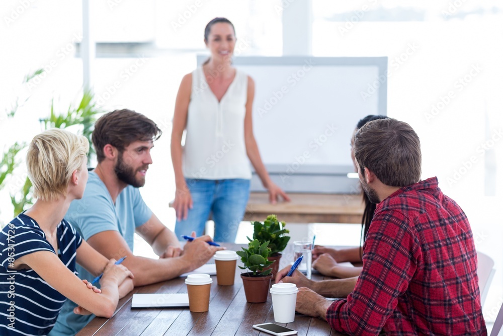 Casual businesswoman giving presentation to her colleagues Casual businesswoman giving presentation to her colleagues
