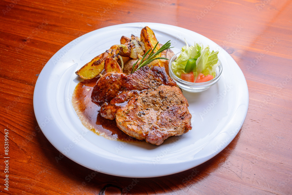 Grilled steak with roasted potatoes and salad Grilled steak with roasted potatoes and salad