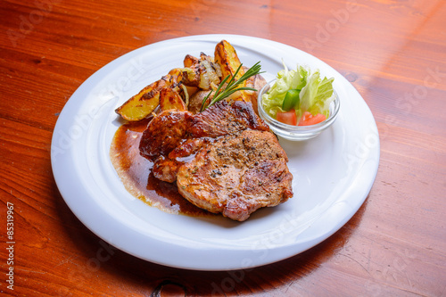 Grilled steak with roasted potatoes and salad