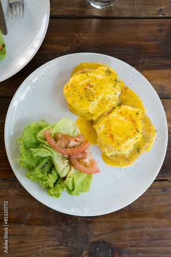 Eggs Benedict with salad top view