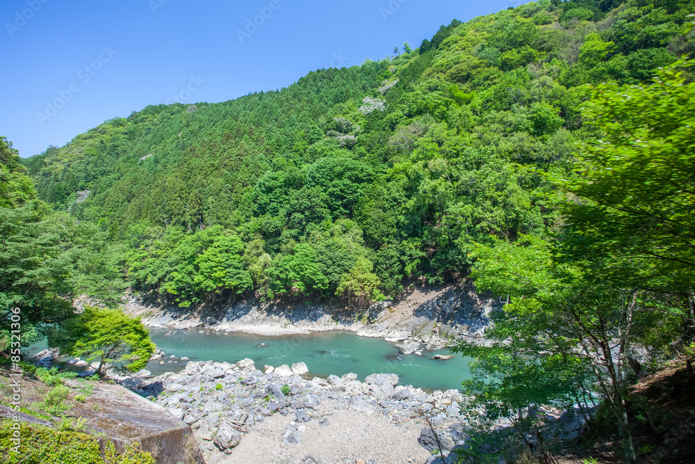 Green mountain and river in summer season at Arashiyama , Kyoto Green mountain and river in summer season at Arashiyama , Kyoto
