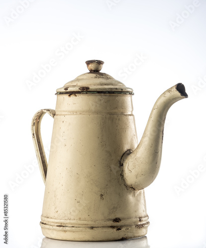Vintage teapot made form metal isolated on white.