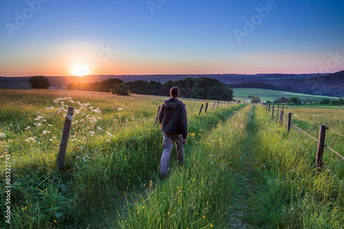 Man walking along Path Towards Sunset © creativenature.nl