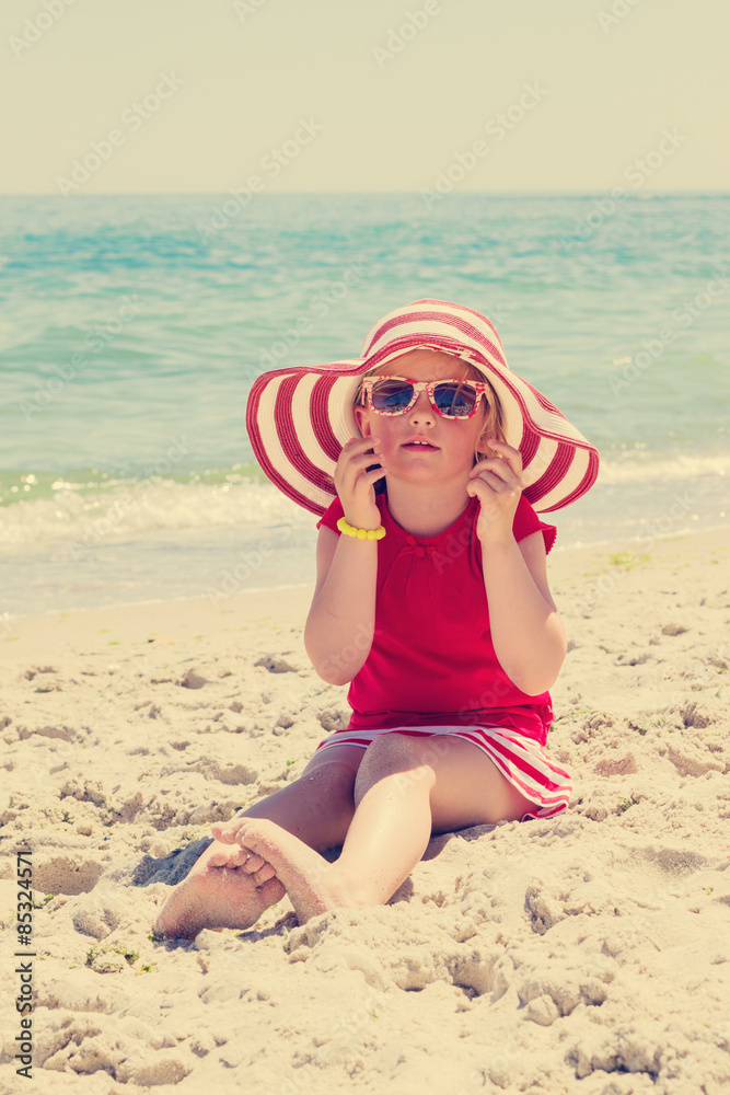 Funny little girl on the beach. The image is tinted. Funny little girl on the beach. The image is tinted.