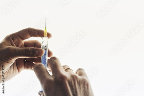 Measuring dosage with syringe photo