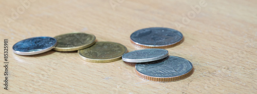 Group of Thai baht coins on Wood floor