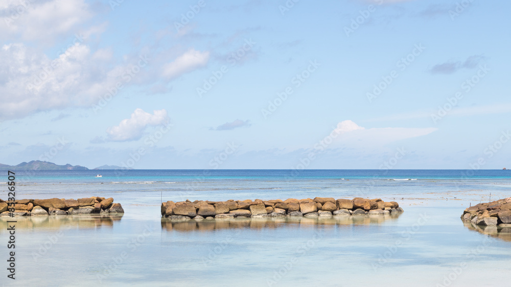 seascape with a breakwater in Seychelles