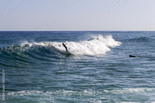 Ocean view and people surfing in Tavira Island, Algarve
