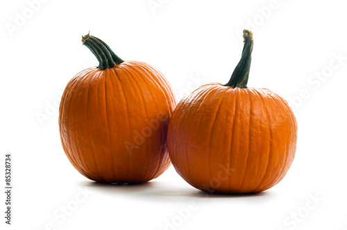 two orange pumpkins on a white background