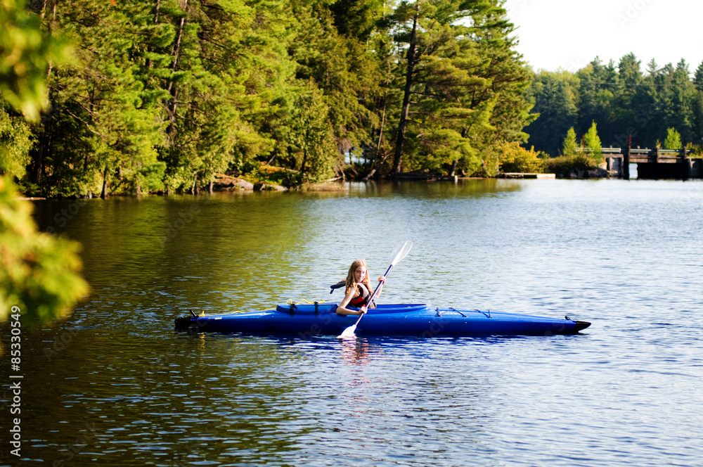 teen girl in a kayak on the lake