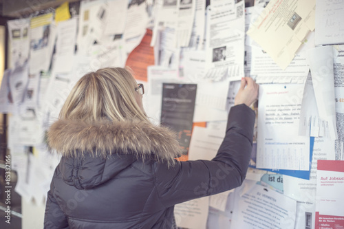 Woman reading at notice board