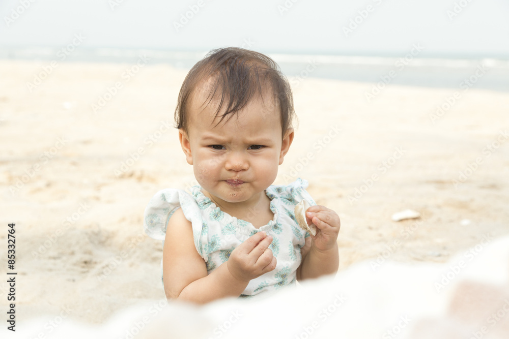 Portrait of baby girl with sand in mouth on the beach Portrait of baby girl with sand in mouth on the beach
