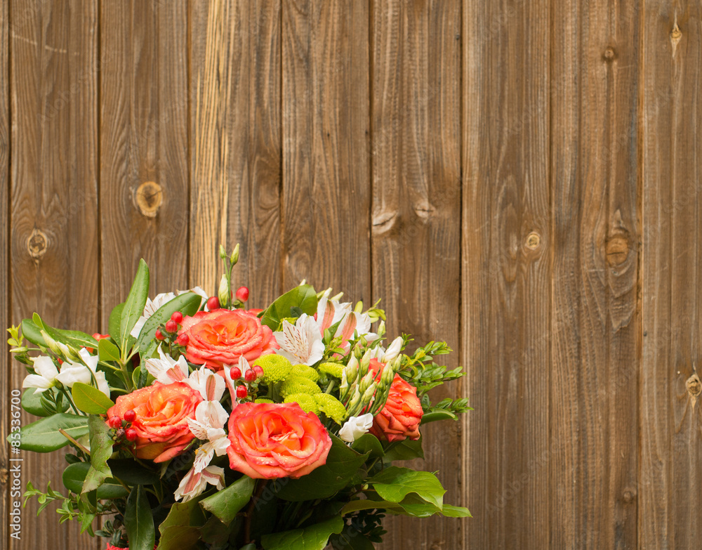 bouquet of flowers on a wooden background.