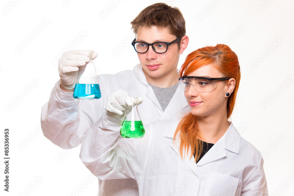 Two chemists holding a test tube in a lab Two chemists holding a test tube in a lab