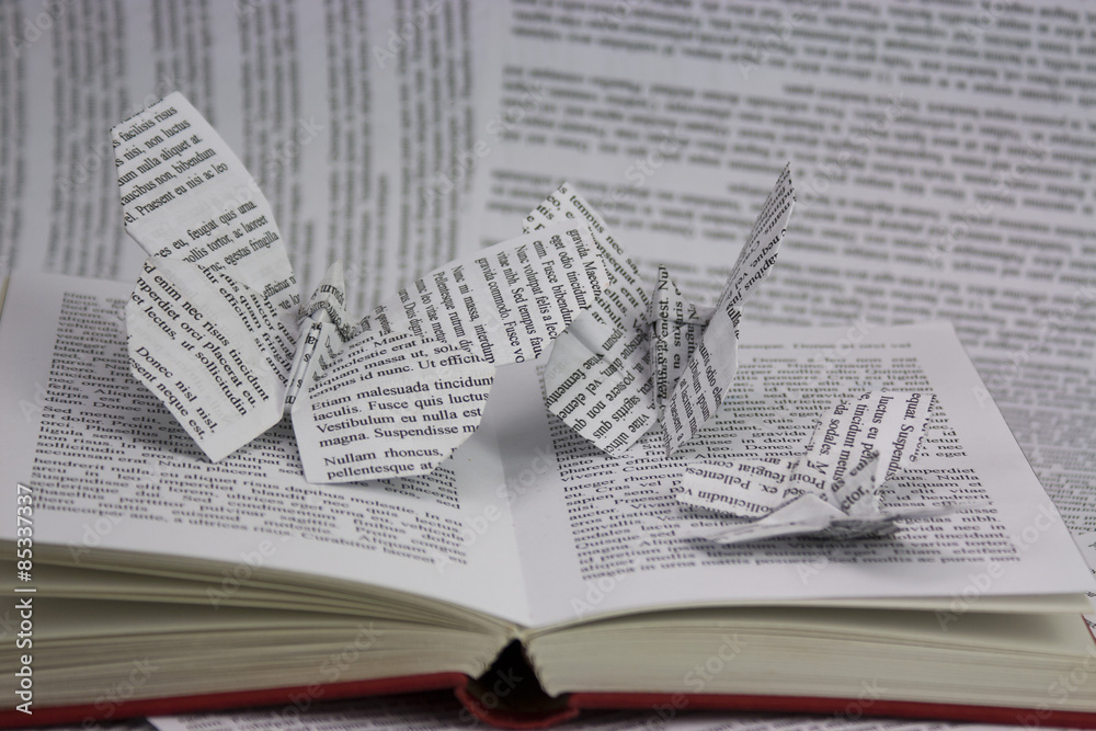 Obraz premium Origami butterflies coming out of a book