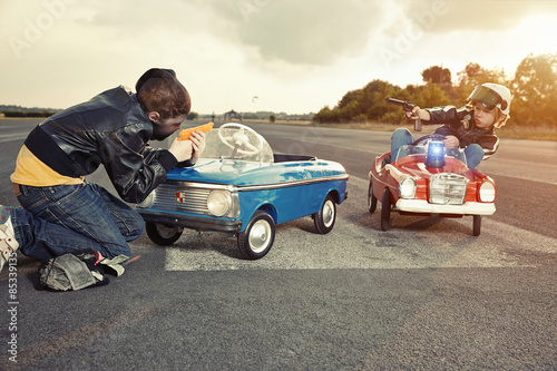 Two boys playing cops and robbers