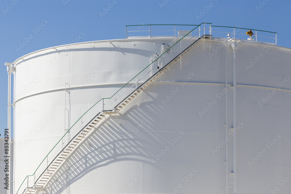 white tanks in tank farm with iron staircase white tanks in tank farm with iron staircase