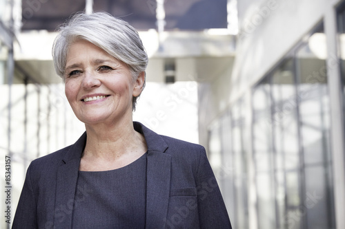 Portrait of smiling career woman in a modern building
