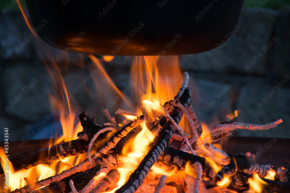 Kochen über dem Lagerfeuer, Flammen unterm Kessel Kochen über dem Lagerfeuer, Flammen unterm Kessel