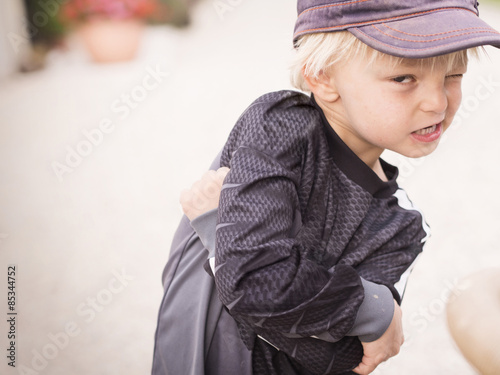 Blond boy pulling funny faces