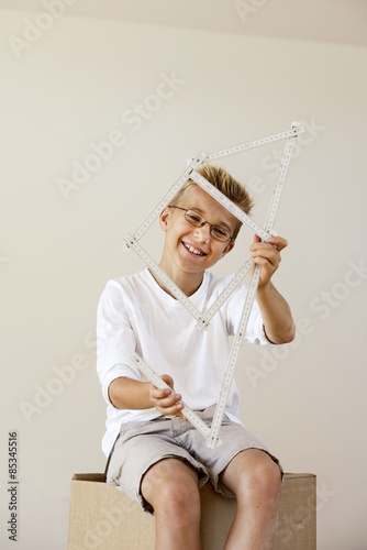 Boy with pocket rule formed like a house
