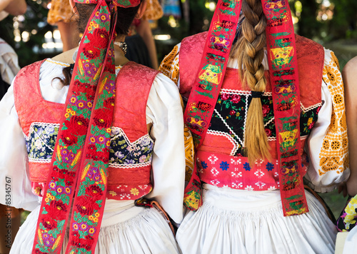 Anonymous girls in folklore costumes, back detail photo
