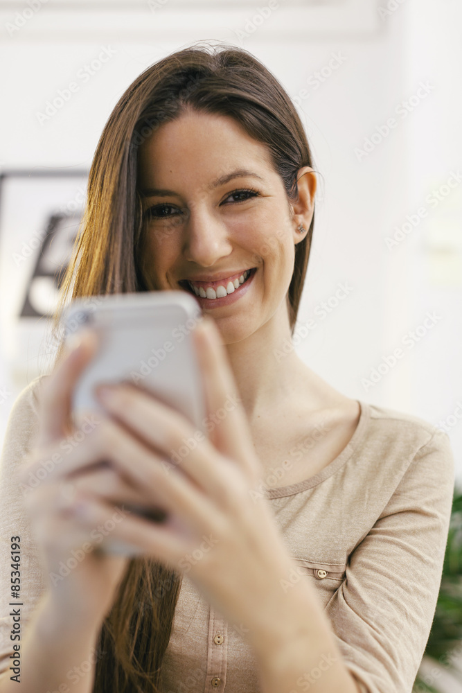 Portrait of young female entrepreneur with smartphone Portrait of young female entrepreneur with smartphone