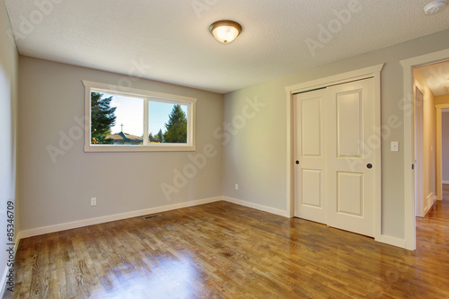 Simplistic hardwood bedroom.