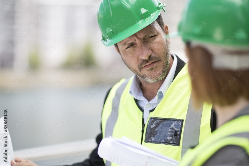 © Westend61 - Manager and foreman discussing construction project on site