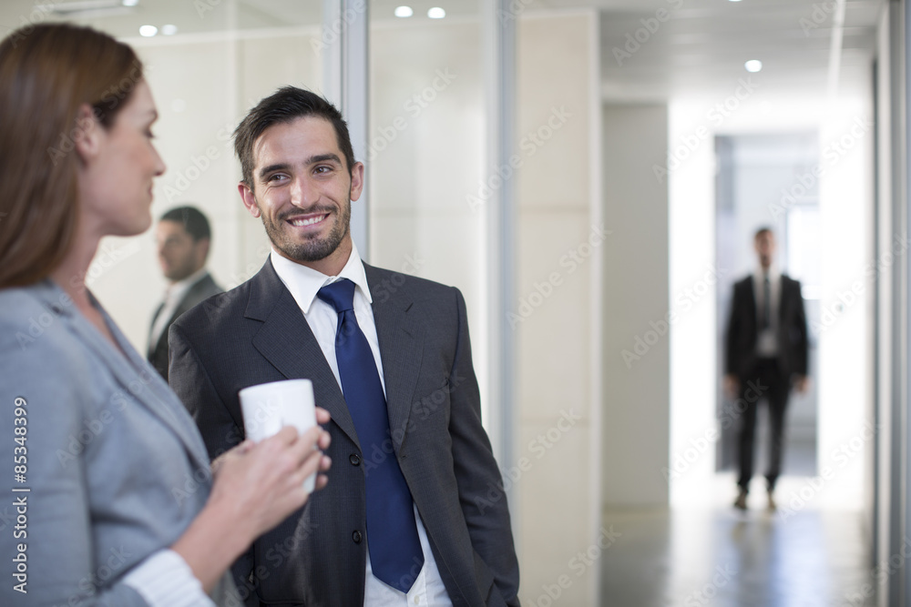 Businessman and businesswoman meeting on office floor Businessman and businesswoman meeting on office floor