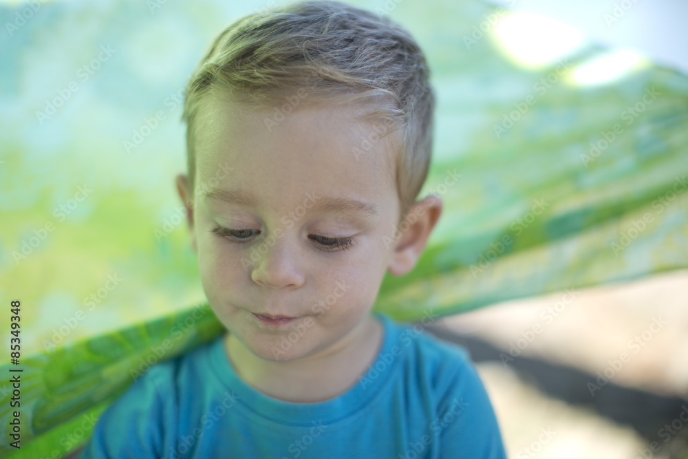 Portrait of little boy outdoors looking down Portrait of little boy outdoors looking down