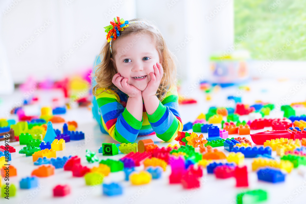 Little girl playing with colorful toy blocks Little girl playing with colorful toy blocks
