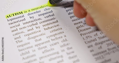 The definition of Autism being emphasized by a yellow marker...
