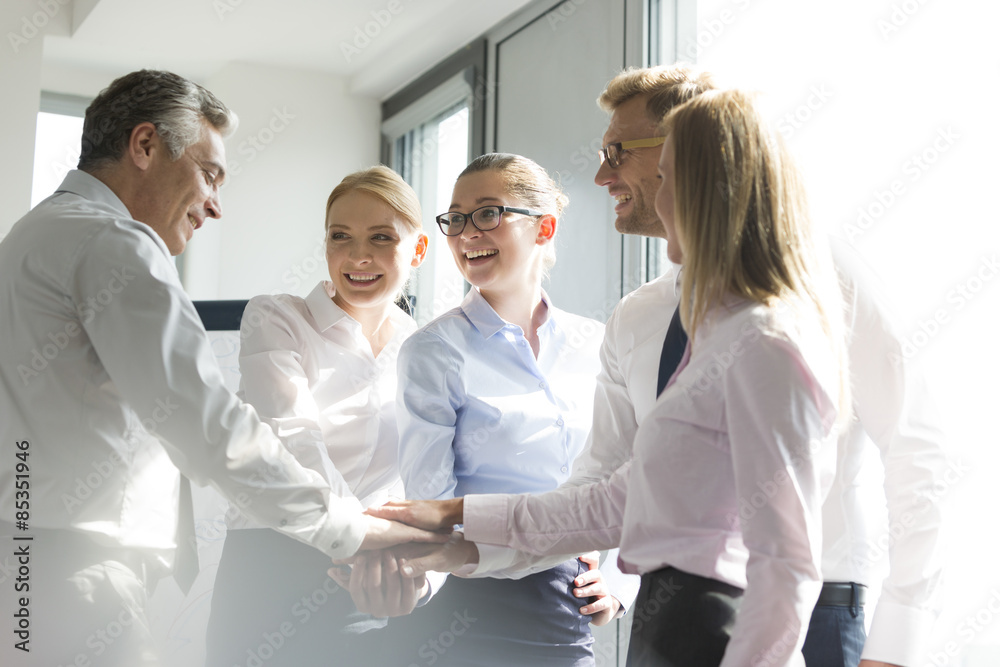 Business people with piled hands, bonding for success