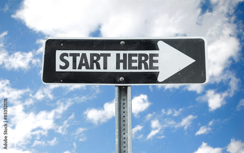 Start Here direction sign with sky background Start Here direction sign with sky background