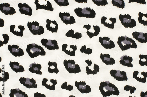 Black and grey leopard pattern. Black and white spotted animal print as background. © luanateutzi