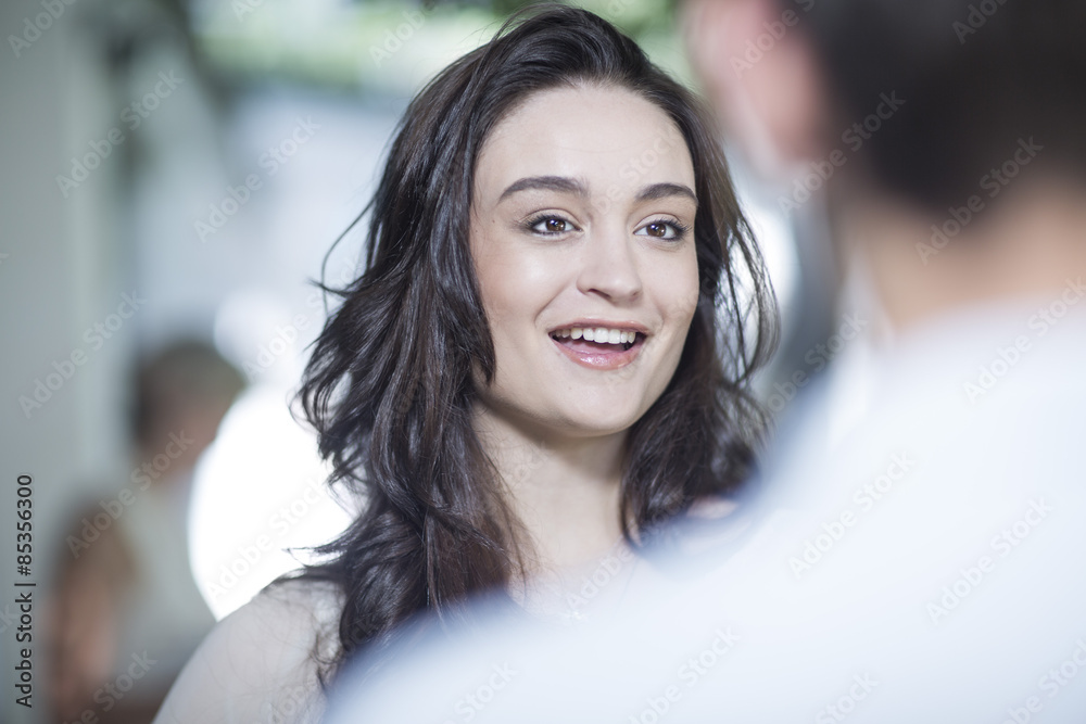 Smiling young woman in a conversation Smiling young woman in a conversation
