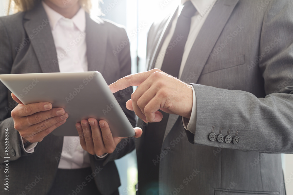 Businessman and businesswoman using digital tablet Businessman and businesswoman using digital tablet