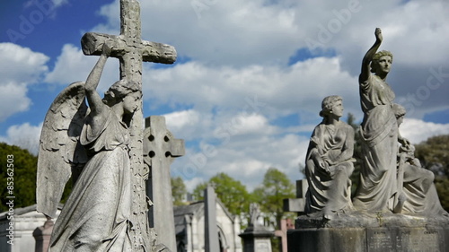 statues, crosses and tumbs in a cemetery photo